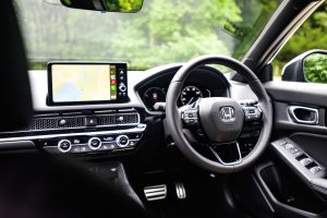 Car steering wheel and screen to represent NIC refunds on car allowances